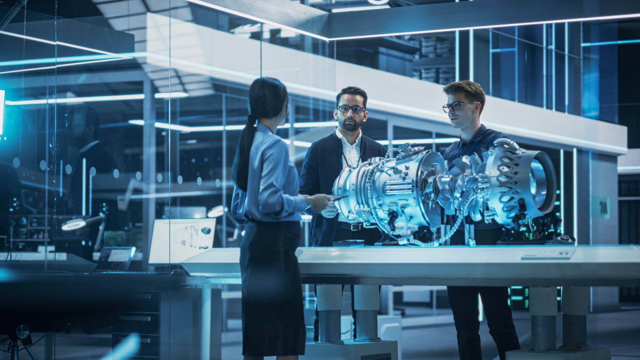 Three people having discussion at work in lab setting.