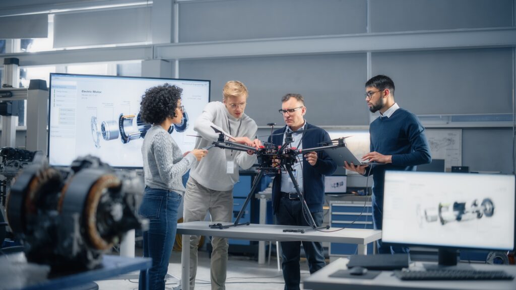 Four people working on a device.